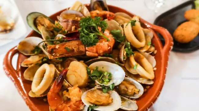 Which Spices and Herbs Give Portuguese Seafood Its Distinctive Flavor?